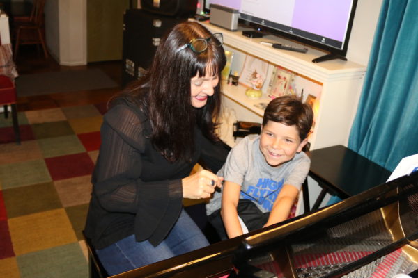 Teacher with boy at piano
