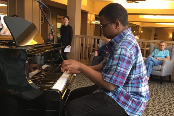 Boy teen playing piano